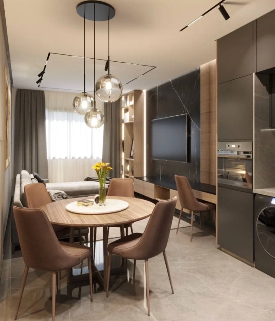 Coin repas après home staging LB Design : table ronde bois, suspensions globes fumés et mur marbre noir