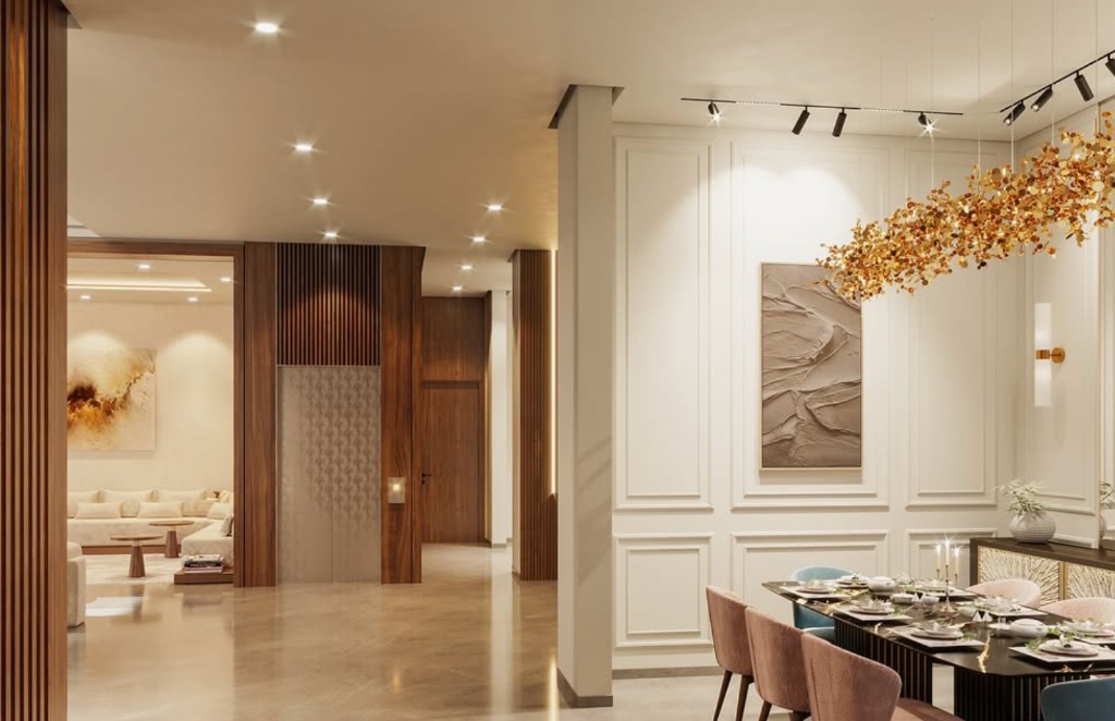Salle à manger avec boiseries blanches, lustre branches dorées, lambris bois et table dressée